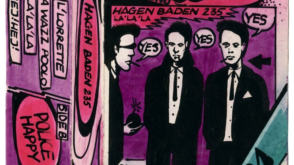 Fioletowo-różowy rysunek w stylu komiksowym. W centralnym punkcie rysunkowe postaci trzech mężczyzn w garniturach, jeden z nich trzyma w ręku bombę.